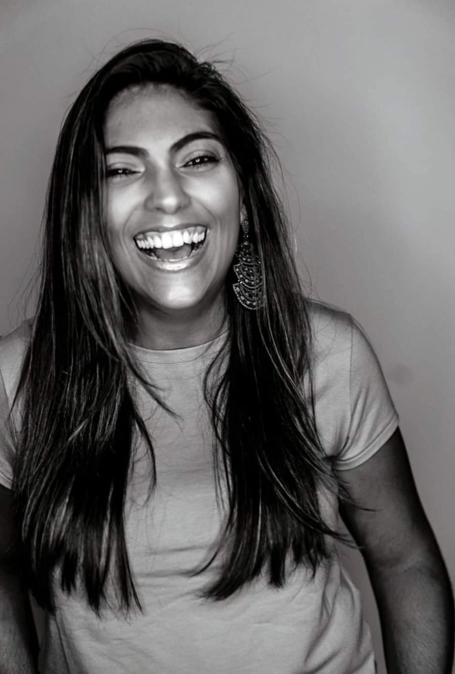 black and white image of Malu Monjardim laughing