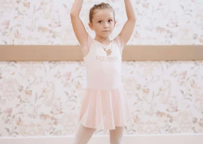 Young ballerina practicing ballet positions